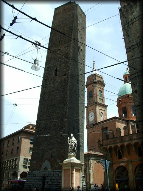 Mesh of wires in the sky. The two towers. Towers from the 12th century on Piazza Ravegnana. Torre degli Asinelli is the straight one and it's 97,20 m. high. Torre Garisenda is the slanted one and it's 47 m. high.