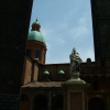 Statue between the two towers. Towers from the 12th century on Piazza Ravegnana. Torre degli Asinelli is the straight one and it's 97,20 m. high. Torre Garisenda is the slanted one and it's 47 m. high.