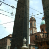 Mesh of wires in the sky. The two towers. Towers from the 12th century on Piazza Ravegnana. Torre degli Asinelli is the straight one and it's 97,20 m. high. Torre Garisenda is the slanted one and it's 47 m. high.