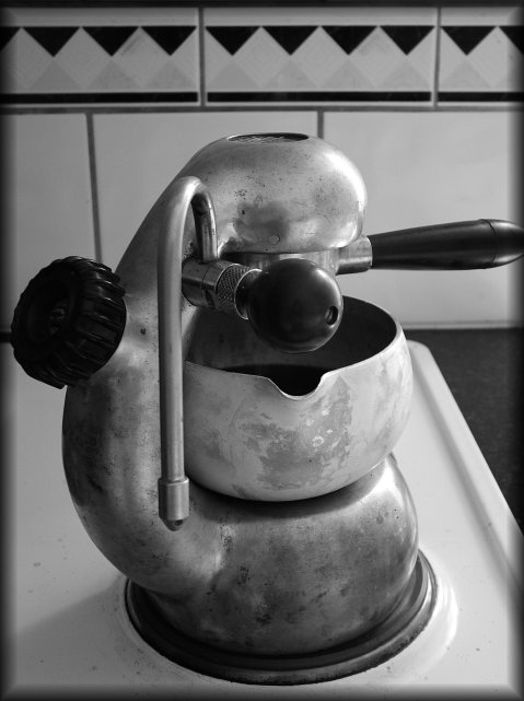 Coffee is slowly brewing on the stove, from a pretty vintage Atomic espresso maker.