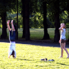 Two girls having fun (it seemed) doing gymnastics on the grass near the entrance of the Vigeland Sculpture Park.