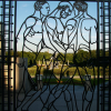 Wrought iron gate at the Vigeland Sculpture Park featuring three naked men on their way. Left pane.