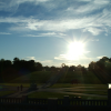 The sun is low on the Vigeland Sculpture Park. Glimpse of the Wheel of life above the threes and under the sun.