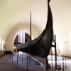 The Oseberg Ship at the Viking Ship Museum</a>.  <em>The Oseberg Ship was found in a large burial mound at the Slagen farm in Vestfold and excavated in 1904. The ship was built in around 815-820 A.D. and had been used as a sailing vessel for many years before it was put to use as a burial ship for a prominent woman who died in 834. The ship, built of oak, was 22 meters long and 5 meters wide. The 12 strakes were secured with iron nails. The ship was designed for both rowing and sailing. With a square sail of about 90 sq. m., it could reach speeds of over 10 knots. The top strake had 15 oar holes.</em>  <em>The skeletons of two women were found in the grave. One, aged 60-70, suffered badly from arthritis and other maladies; the second was aged 25-30. It is not clear which one was the most important in life, or whether one was sacrificed to accompany the other in death. Although the high-ranking woman's identity is unknown, it has been suggested that it is the burial of Queen Asa of the Ynglinge clan, mother of Halfdan the Black and grandmother of Harald Fairhair. This theory is now generally dispelled, and it is now thought that she may have been a priestess.</em>