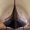 The Gokstad Ship at the Viking Ship Museum.  <em>The Gokstad Ship was found in a large burial mound at the Gokstad farm in Sandar, Vestfold in 1880. The ship had been built around 890 A.D. and later used in the ship burial of an important chieftain who died in or around 900 A.D. The ship, built of oak, is 24 meters long , 5 meters wide and is the largest of the three ships in the museum. It could accomodate 32 oarsmen and was much more sturdily built than the Oseberg ship. The keel and mast step are sturdier and the ship's sides are higher, with two strakes above the oar holes. The oar holes could be hatched down when the ship was under sail. Using a square sail of 110 sq. m., the ship could reach speeds of over 12 knots.  Just how seaworthy it had been, was demonstrated when a copy of the Gokstad Ship sailed the Atlantic from Bergen to the World's Fair in Chicago in 1893.</em>  <em>During the excavations, the skeleton was recovered of a male aged between 50-70 years. The skeleton was found in a bed in a timber-built burial chamber. Although the identity of the person buried is unknown, it has been suggested that it is that of Olaf Geirstad-Alf, a petty king of Vestfold.</em>