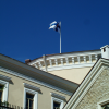 Estonian flag against a deep blue sky