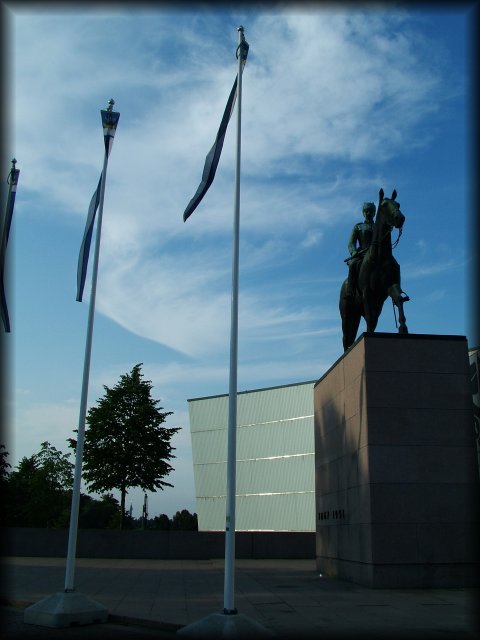 This is the statue of Gustaf Mannerheim, the Marshal of Finland. Three flags. 