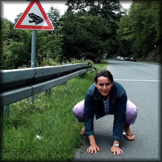 Bellie pausing as a frog, next to the beware of the frog sign, Eltville am Rhein, Germany