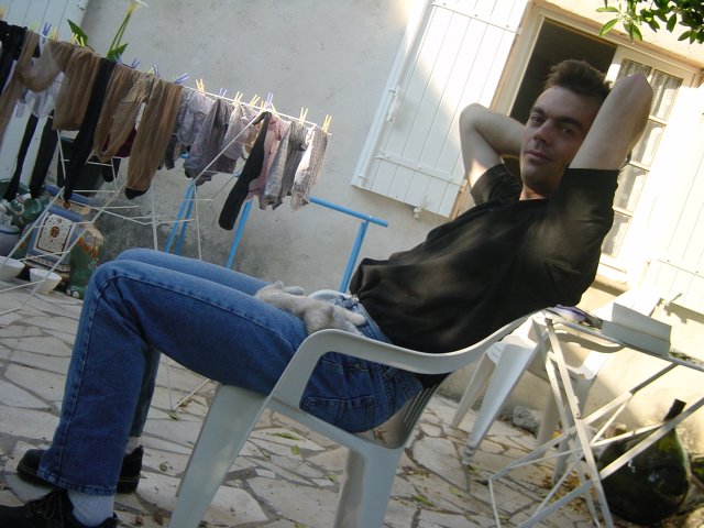 Emu sleeping on Steph's lap on the terrasse