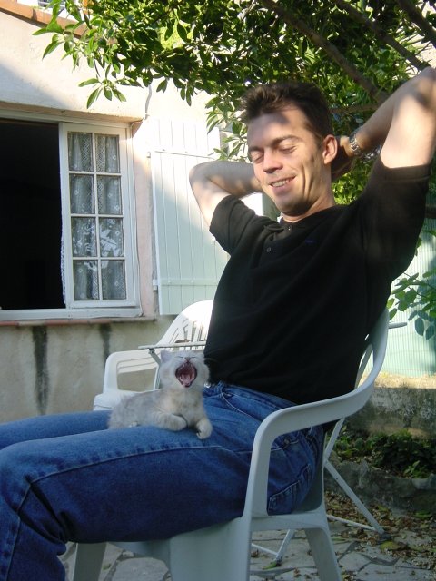 Emu yawning on Steph's lap on the terrasse