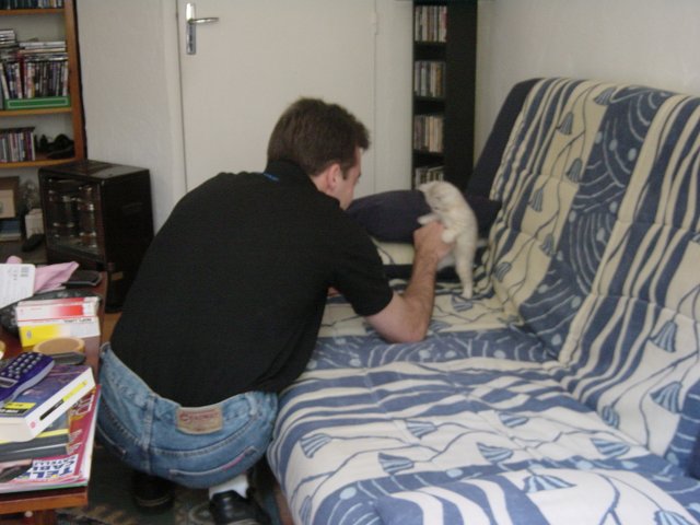 Steph playing with Emu on the couch