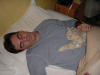 Steph sleeping with Emu sleeping on his belly