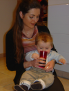 Alexis on Coralie's lap. I think he liked the coolness of the glass, he reached for it and stick his tongue on it.