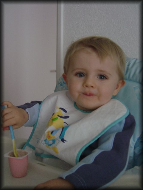 Alexis seems proud that he can eat his yoghurt without help