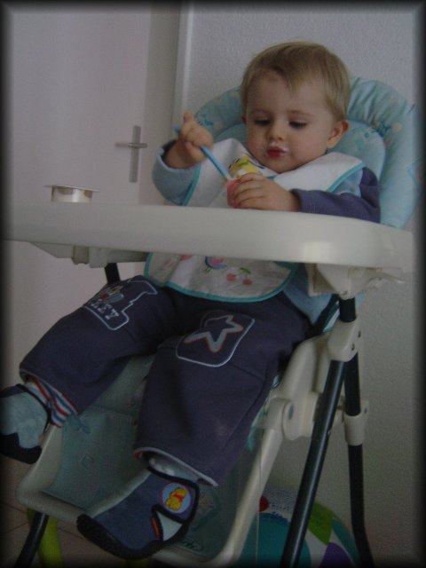 Alexis on his chair eating his yoghurt