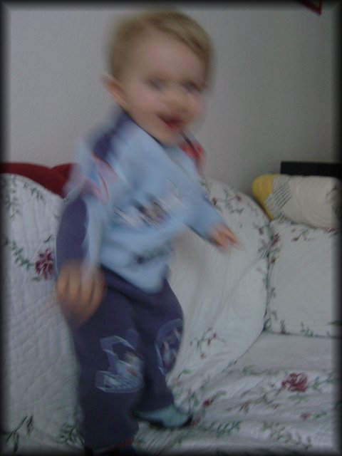 Alexis dancing frenetically on the couch