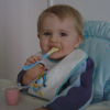 Alexis smiling and eating his yoghurt