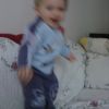 Alexis dancing frenetically on the couch