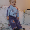 Alexis still standing up on the couch, leaning, mesmerised by the TV