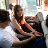 Ian and Coralie in a bus in Hong Kong, Ian in a attempt at curing Coralie's headache by pressing her wrists