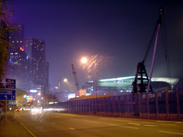 Night picture of purple sky, orange road, specks of light from buildings