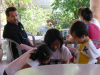 Daniel watching chinese children at a nearby table, Ian and Christelle having lunch