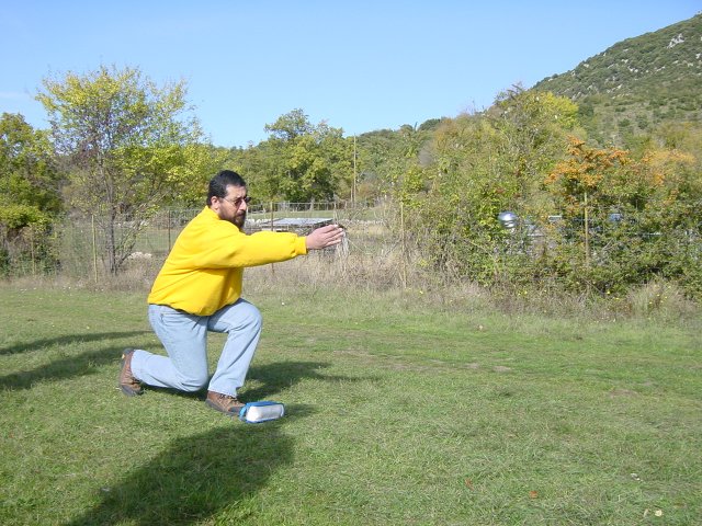 Simon throwing, a knee almost to the ground