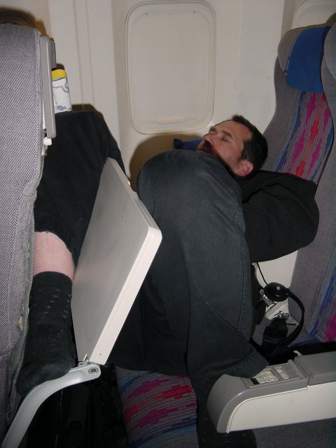 Daniel sprawled in his row, sleeping