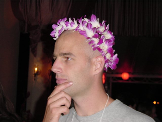 Dean with a lei on his head, holding his chin
