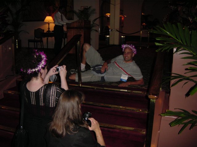 Amy and Caroline taking picture of Dean pausing on the floor