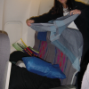 Caroline in the process of covering Sleeping-Daniel with a blanket