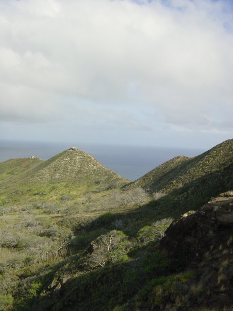 Inside the crater, pyramid like hills and ocean in the back