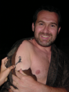 Daniel prouding showing a tattoo on his arm