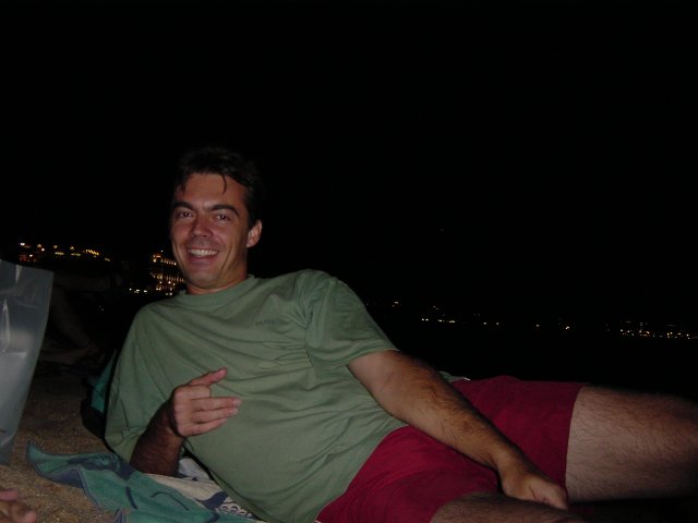 Stephane lying on the beach and smiling