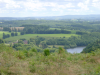 Chateau de Peyrusse a gauche, bras du Thaurion a droite, prairies et forets dans le fond