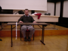 Bartok room: Daniel sitting at a table in front of the stage and screen