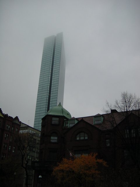 High building with top in the fog