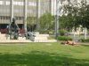 Statue of sitting bronze man and sleeping flesh man