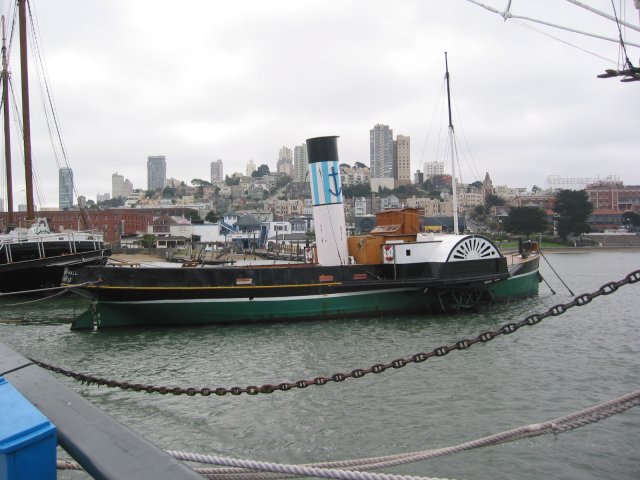 Old boat and city buildings
