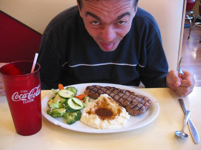 Stephane in front of his plate of steak
