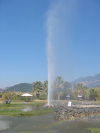 Rainbow on foreground and geyser