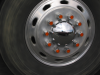 Reflection of our car in the shiny wheel of a truck