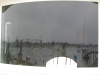 Reflection of the harbour in a curved window