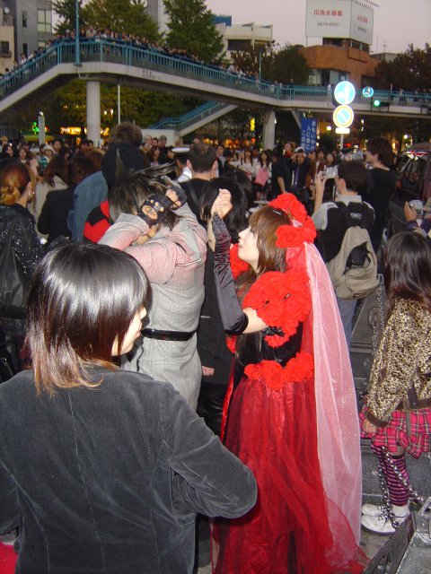 Costumed people (in the background the police ask the band to stop playing)