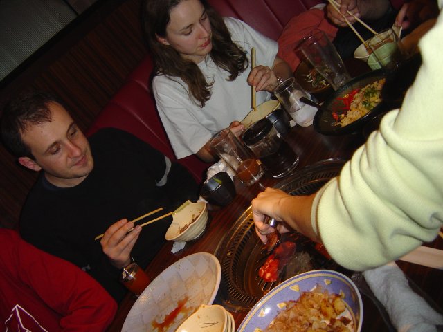 Hugo, Carine and the hand of Alex bbqing meat