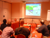 SVG people playing Mario Kart on a large screen