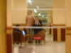 (Blurry in a mirror:) Karl sitting in front of his laptop, Olivier standing next to a dwarf Coralie