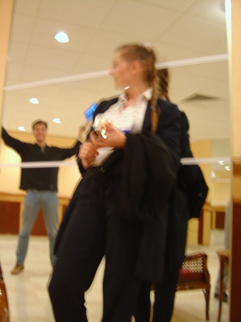 Blurry again in a mirro: Karl raising his arms, Coralie leaning on the mirror
