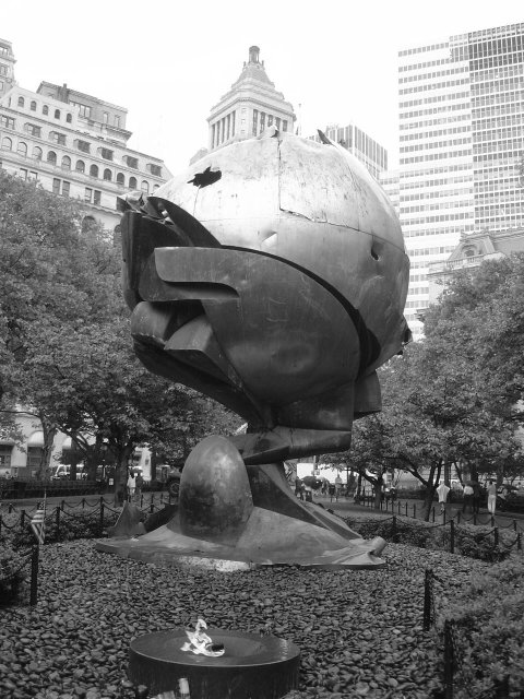Sculpture from the WTC damaged during September 11 and exposed in Battery park as a tribute with eternal flame 