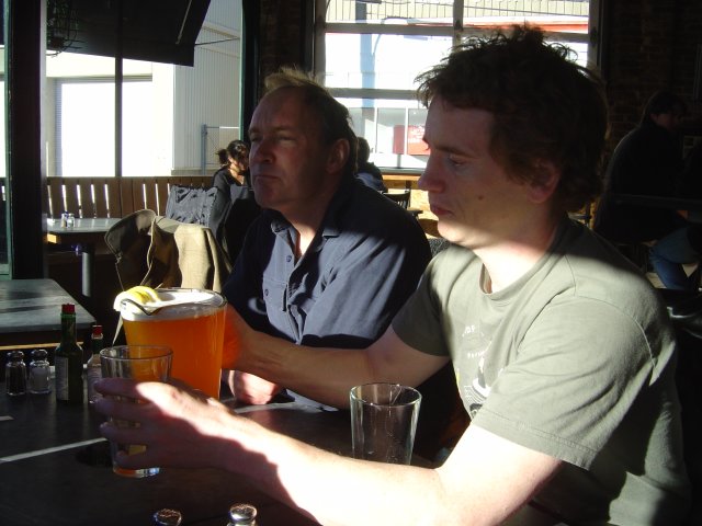 Tim making a face and EricP holder a pitcher of bier